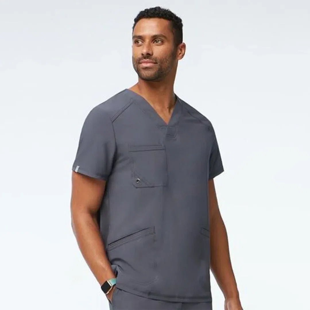 A diverse group of healthcare workers wearing custom fitted V-neck scrub tops, smiling confidently while engaging in their medical duties.