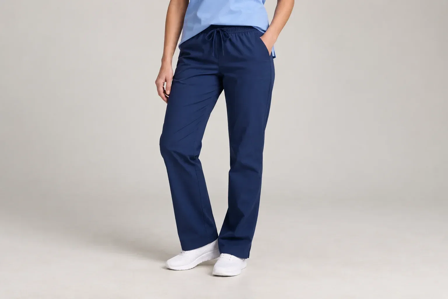 AI-generated illustrative studio image focused on a model wearing plain navy scrub trousers